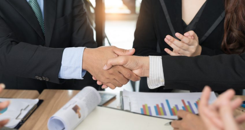 Close-up of handshake during a PE transaction